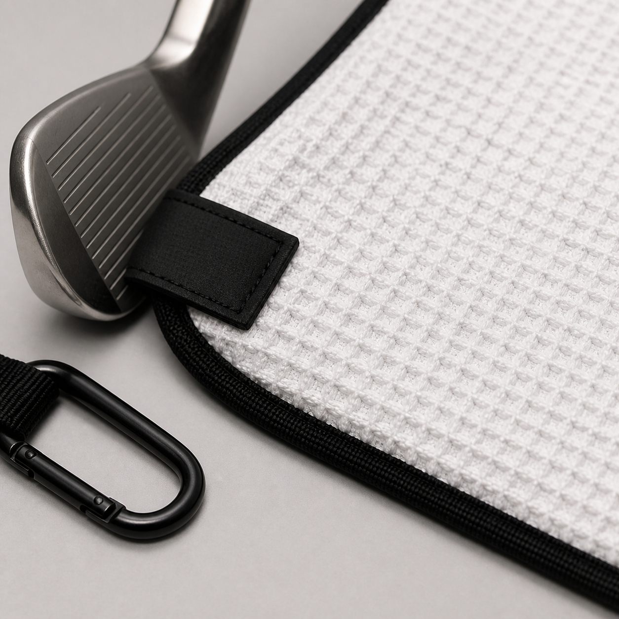 Close detail of waffle weave magnetic tab and carabiner