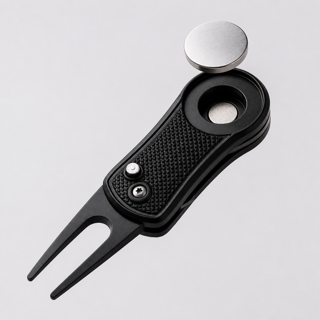 Removable magnetic ball marker lifted above black divot repair tool